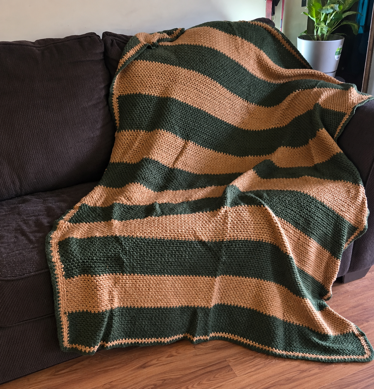 Dusk in the Pines handmade crocheted afghan displayed on a sofa