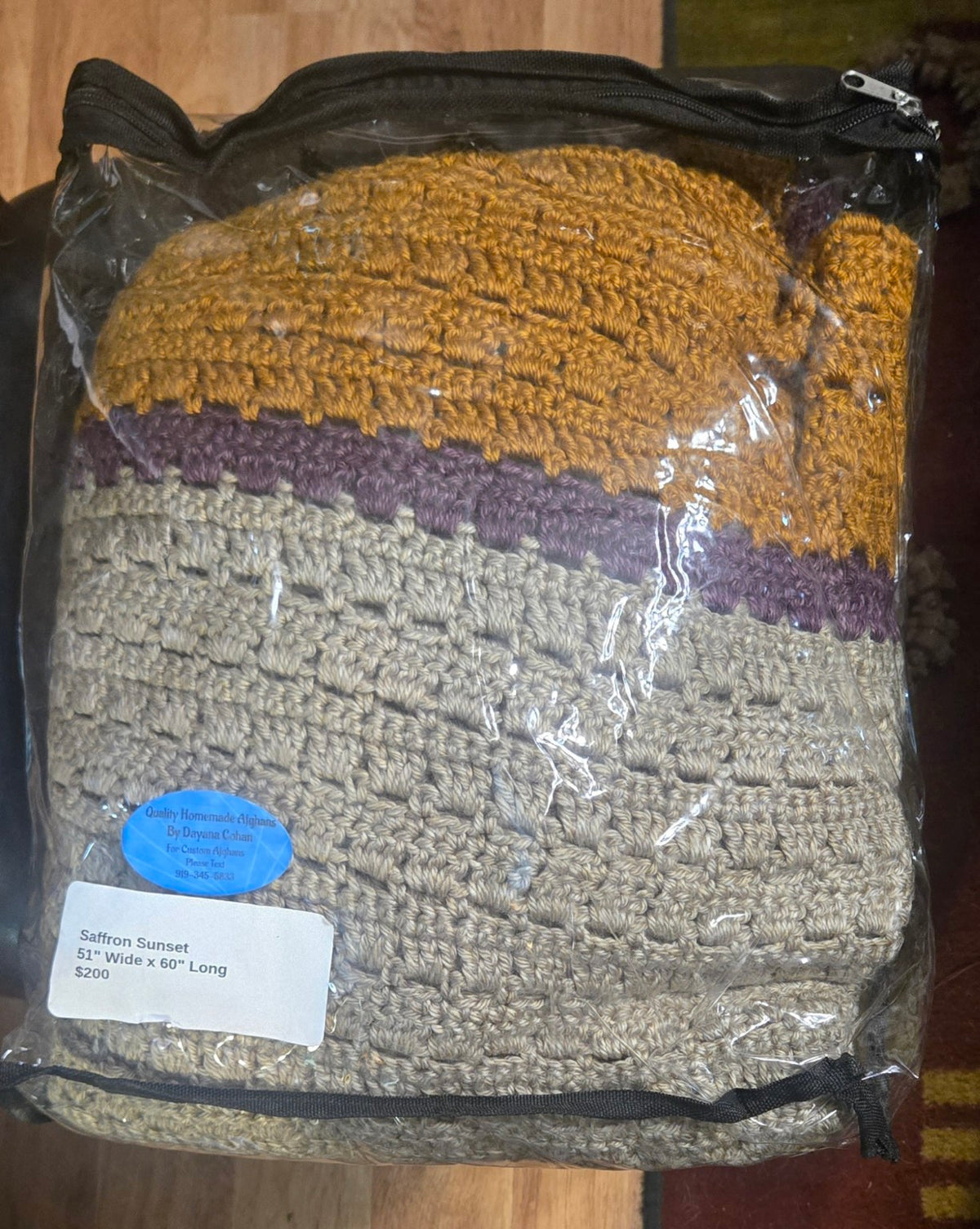 Saffron Sunset handmade afghan in its protective storage case