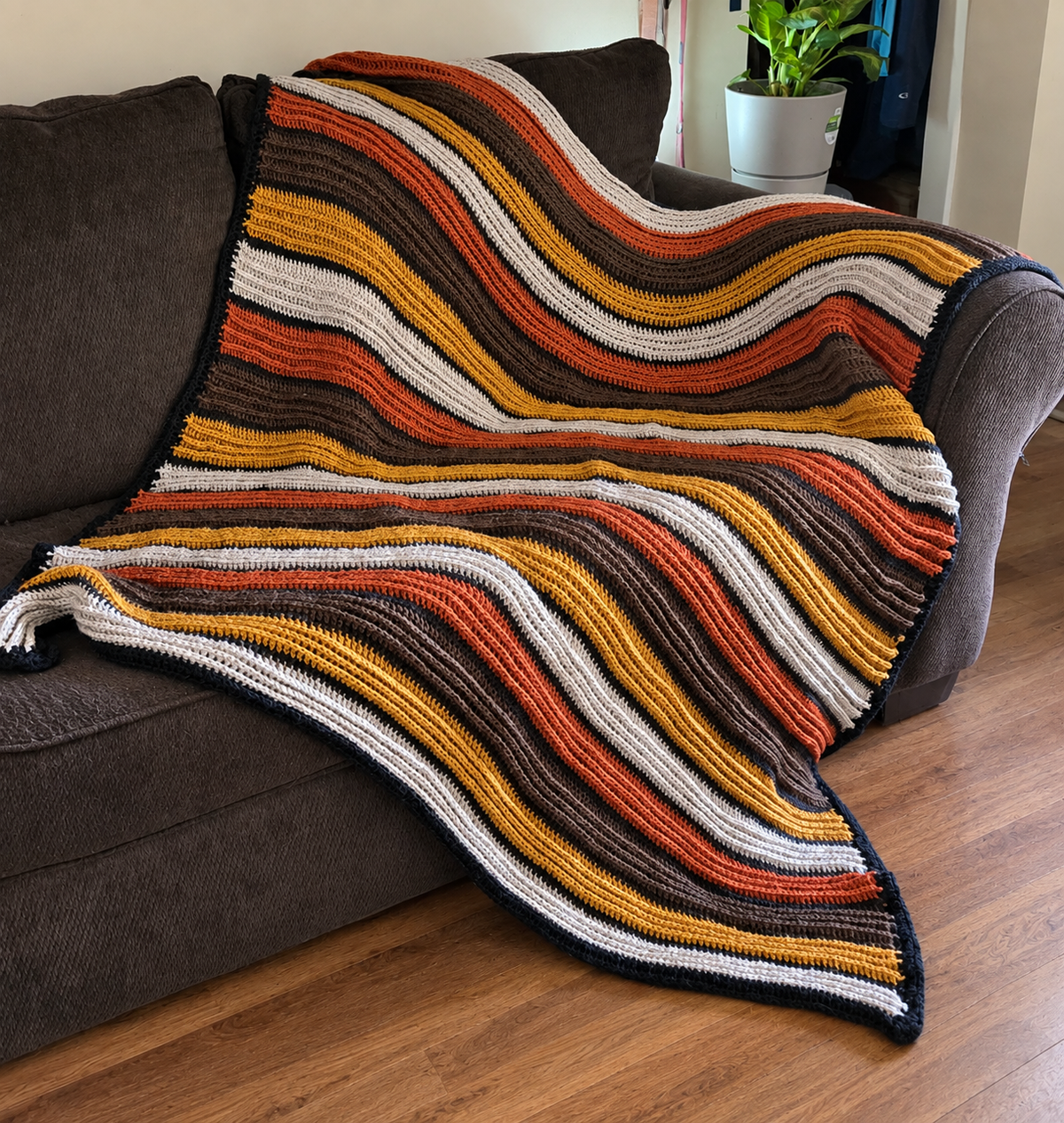 Vintage Campfire handmade crocheted afghan displayed on a sofa